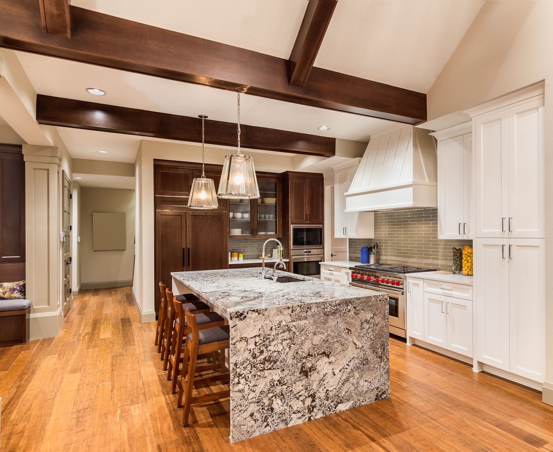 A kitchen with granite counter tops and a stainless steel sink