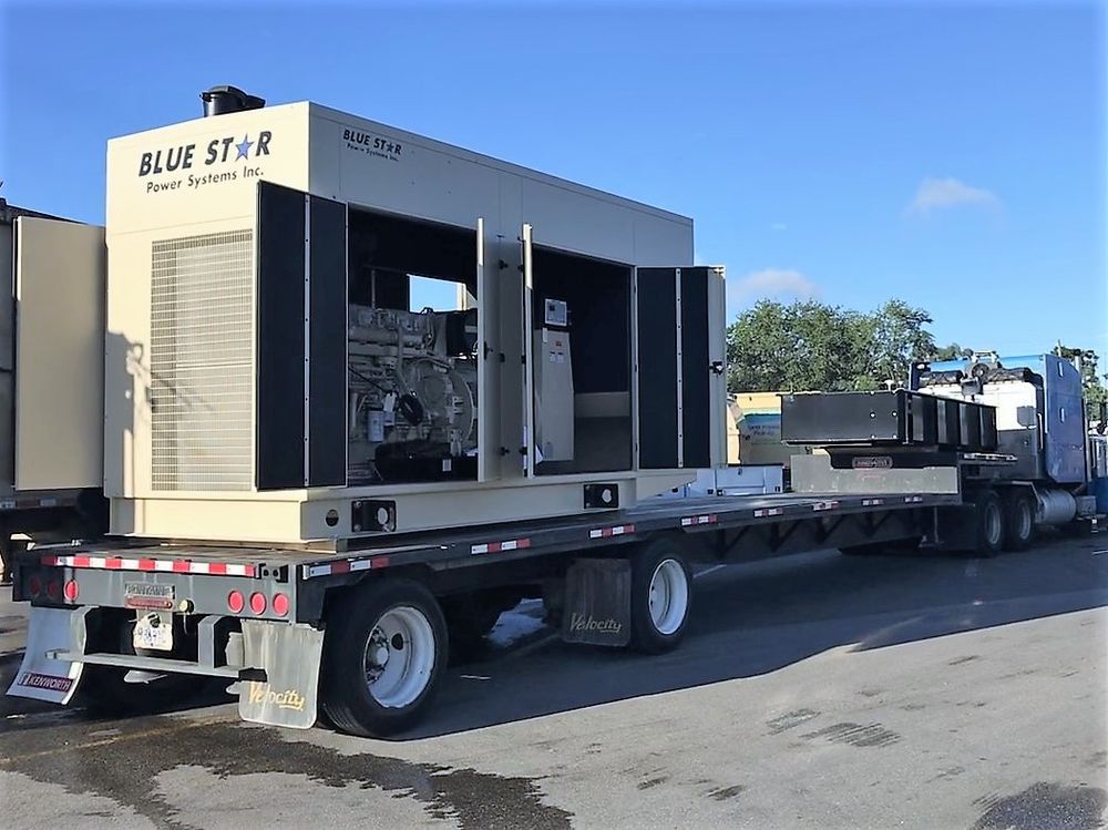 Large Blue Star truck-mounted industrial machine parked on a flatbed trailer in a lot.