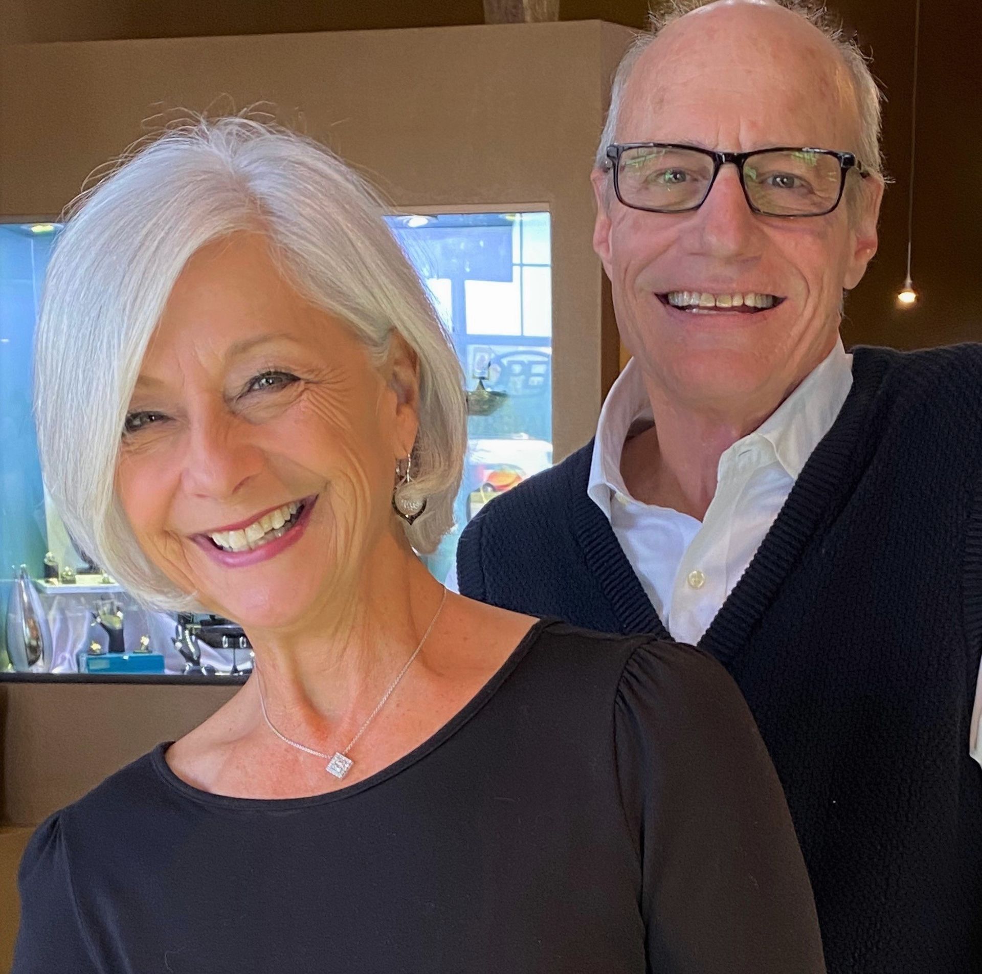 A man and a woman are posing for a picture and smiling