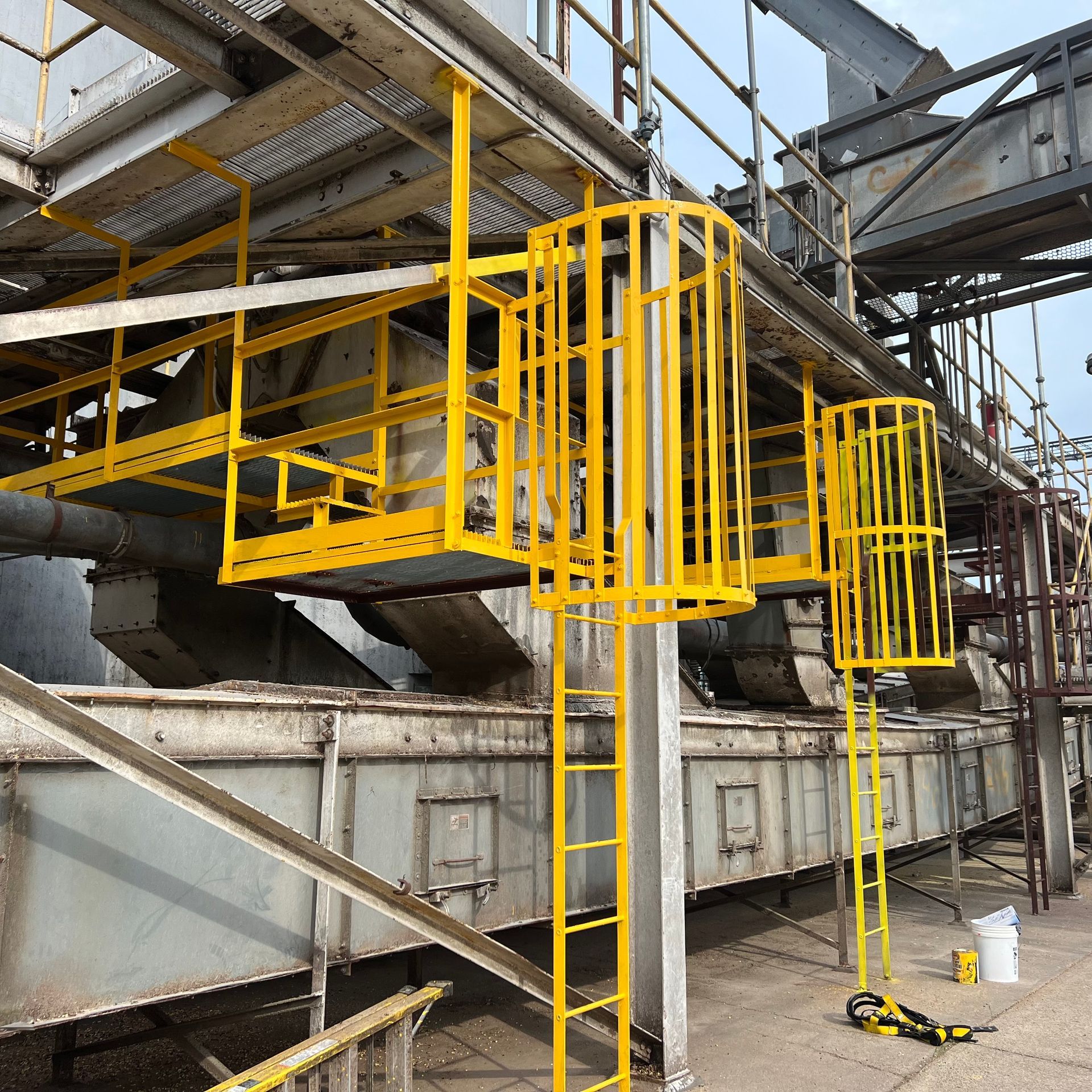 A yellow ladder is attached to the side of a building