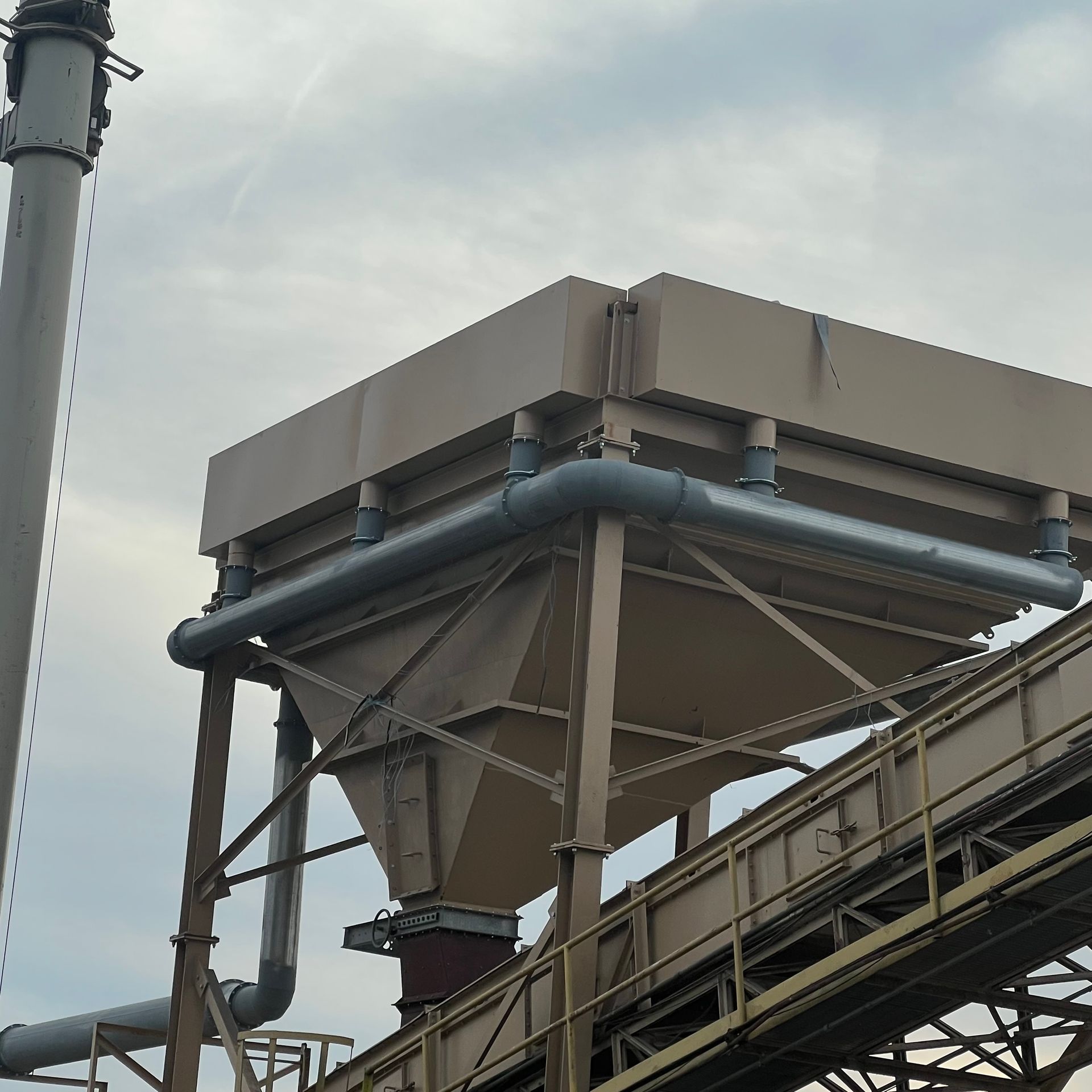 A large metal structure with a conveyor belt going through it