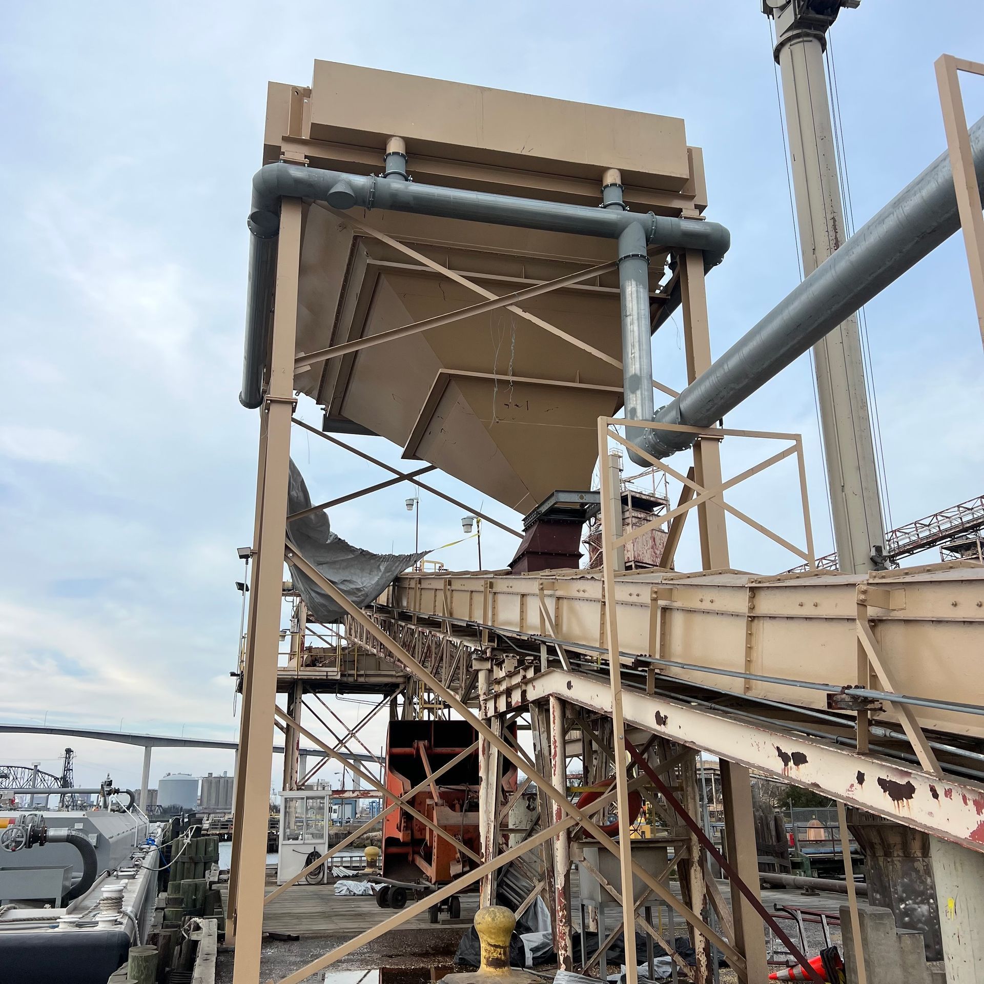 A large metal structure with a boat in the background