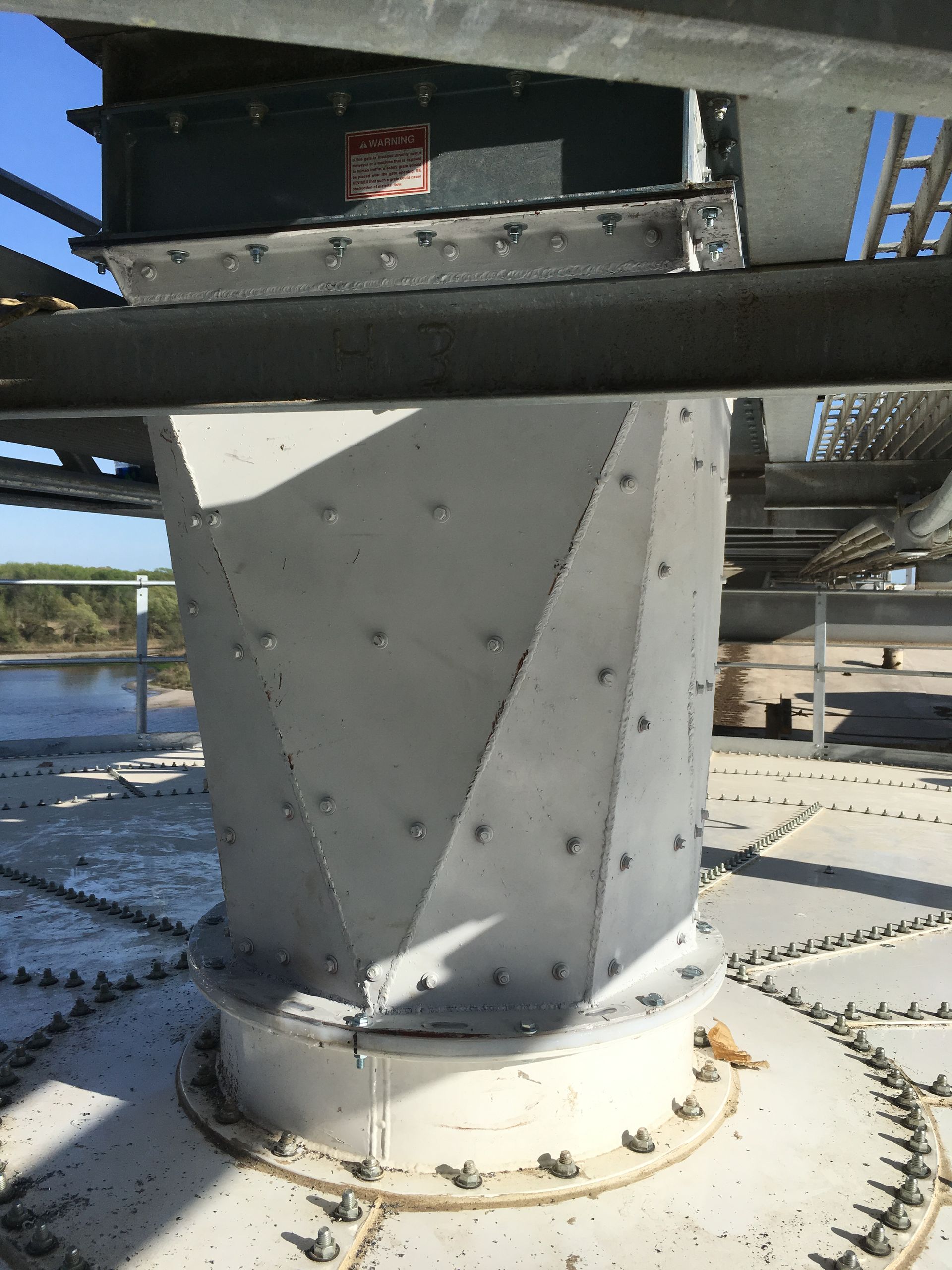 A close up of a metal structure with a blue sky in the background