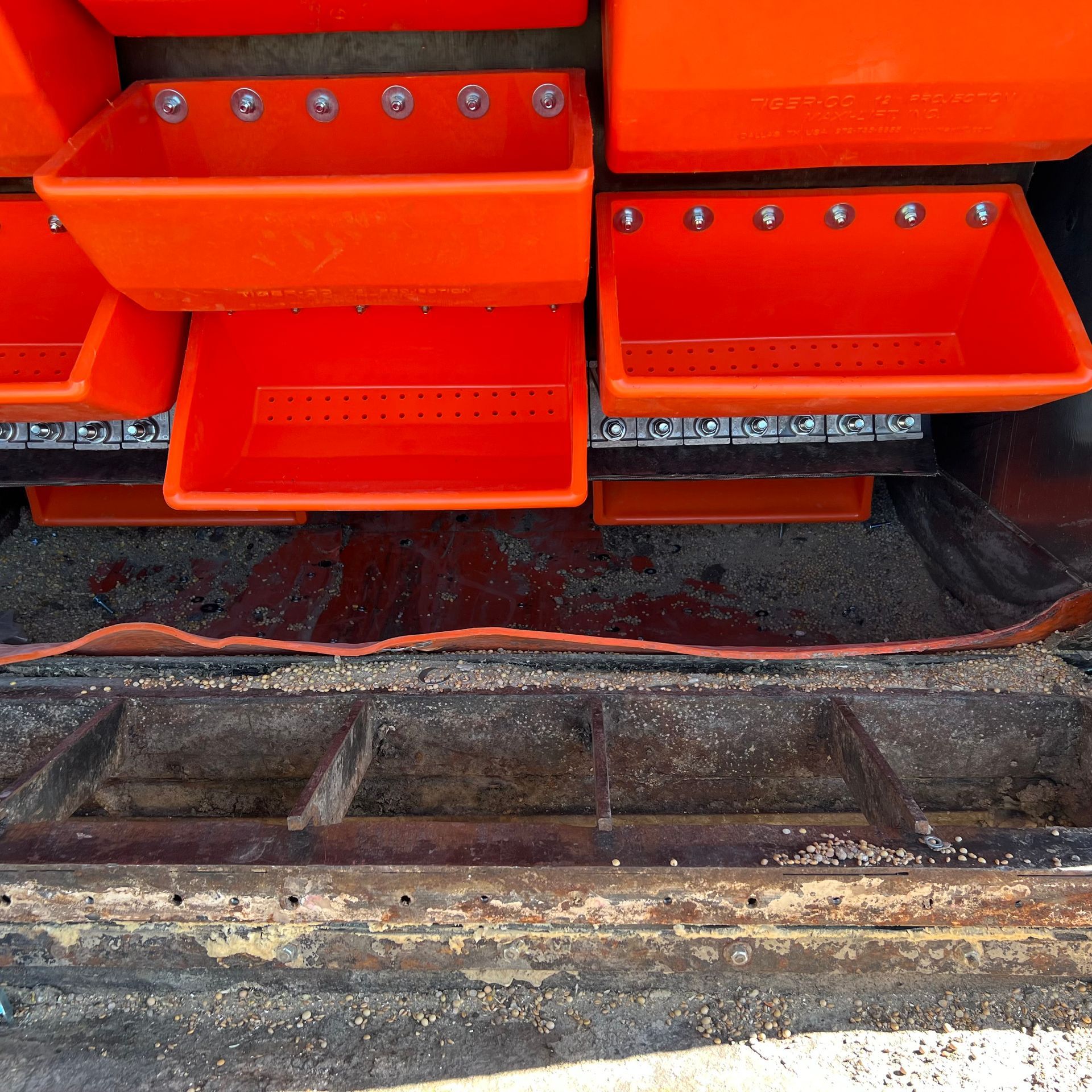 A bunch of orange bins are stacked on top of each other