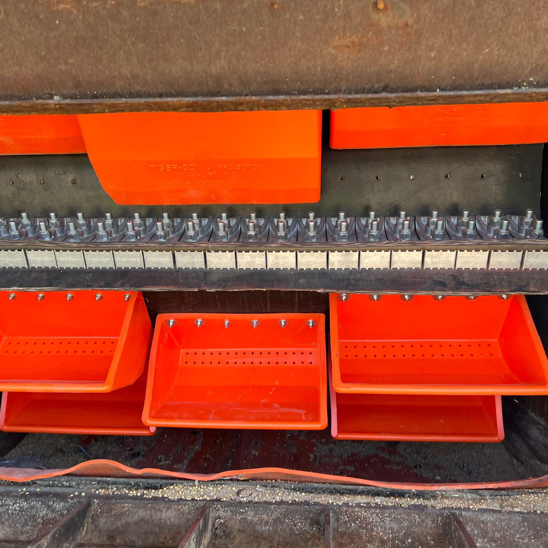 A row of orange bins sitting on top of a piano keyboard
