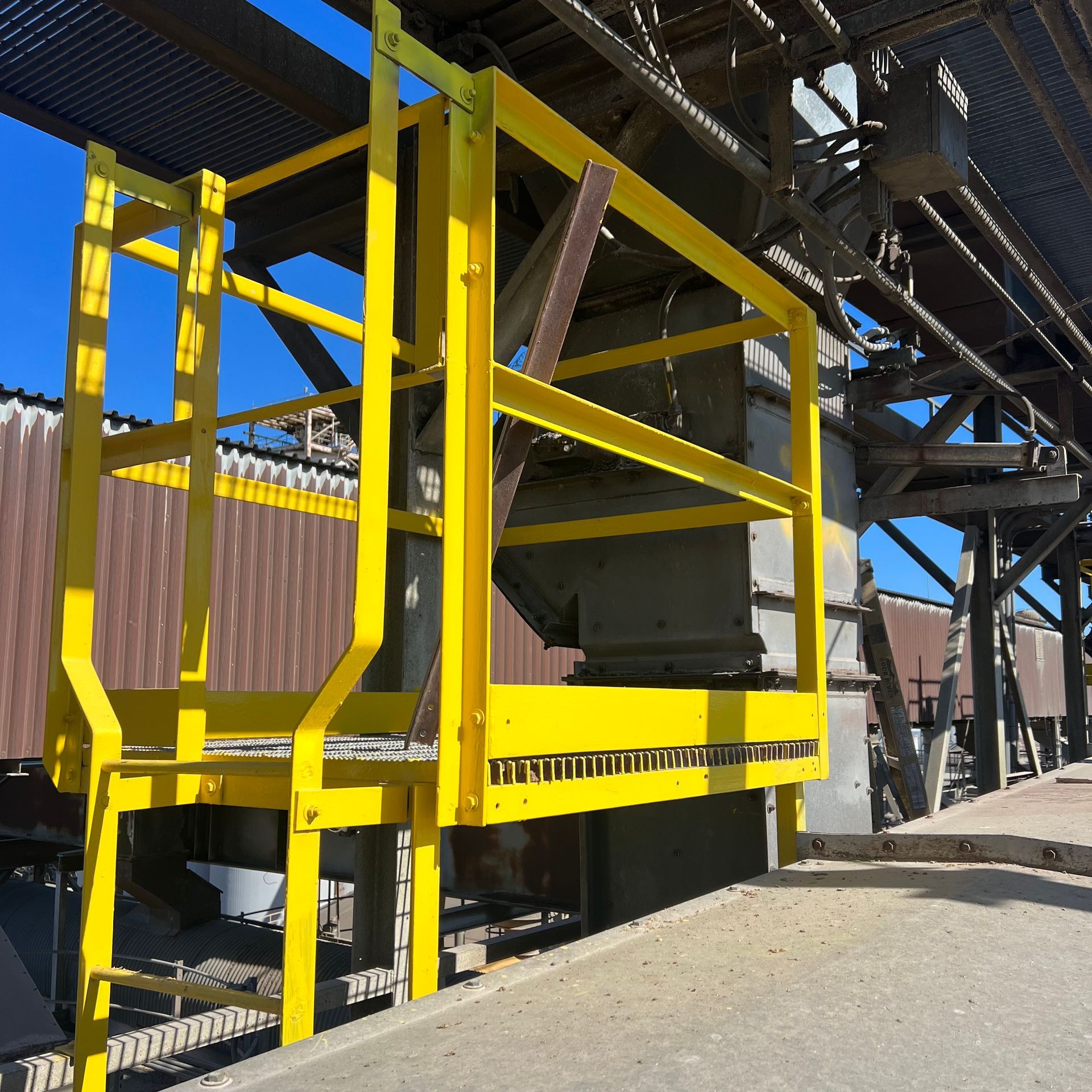 A yellow ladder is attached to a metal structure