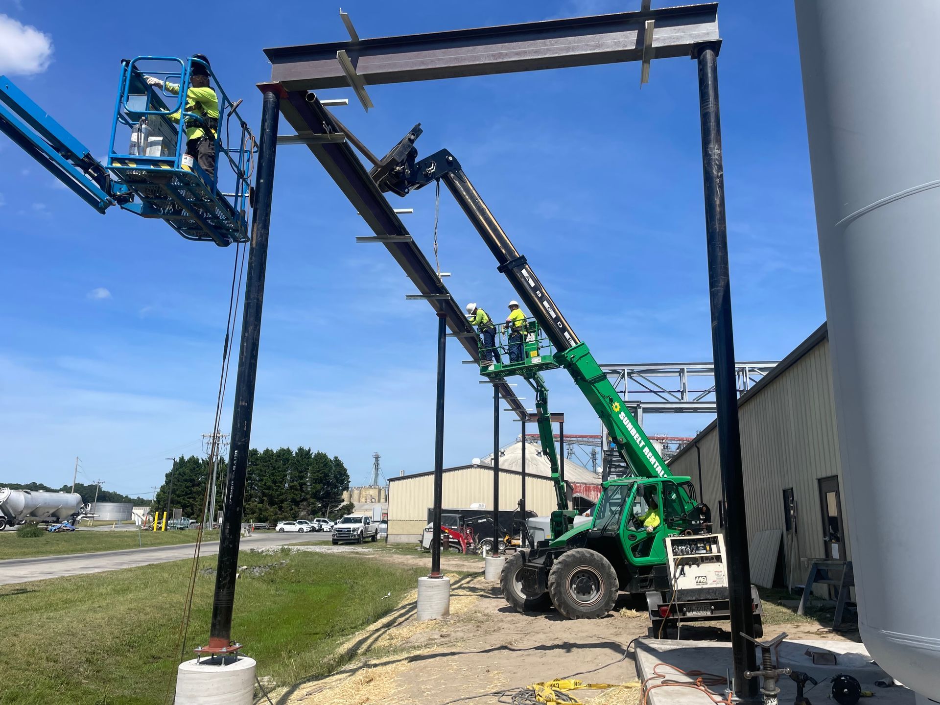 A group of construction workers are working on a metal structure