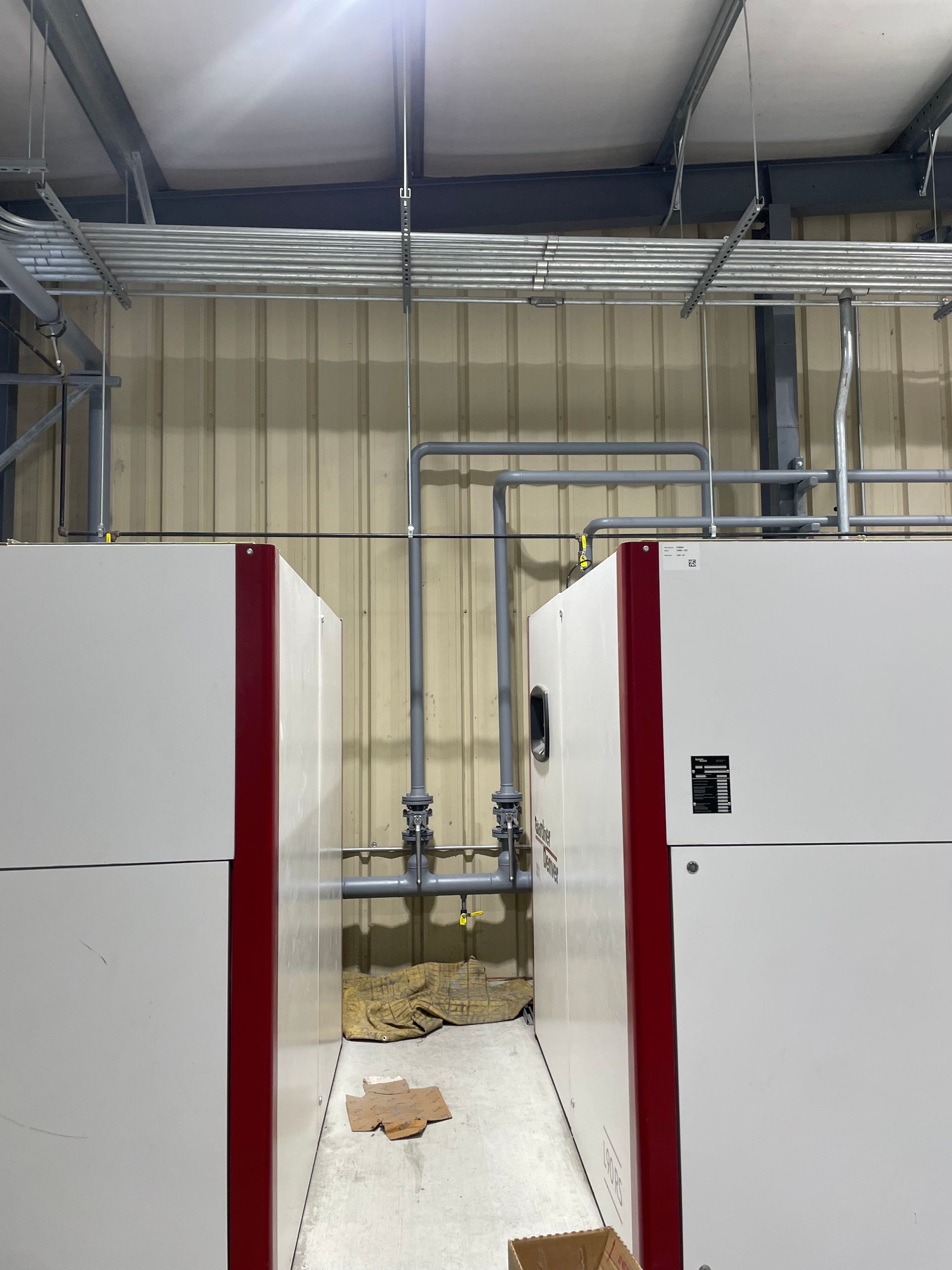 Two white boxes with red trim are sitting next to each other in a room