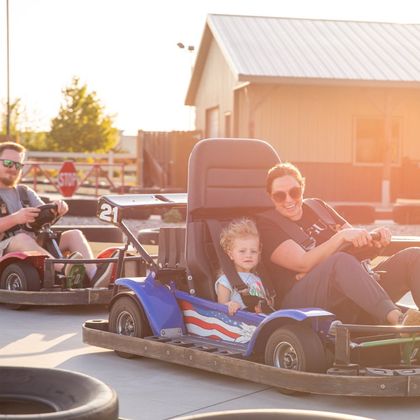 Family having fun while riding go-karts