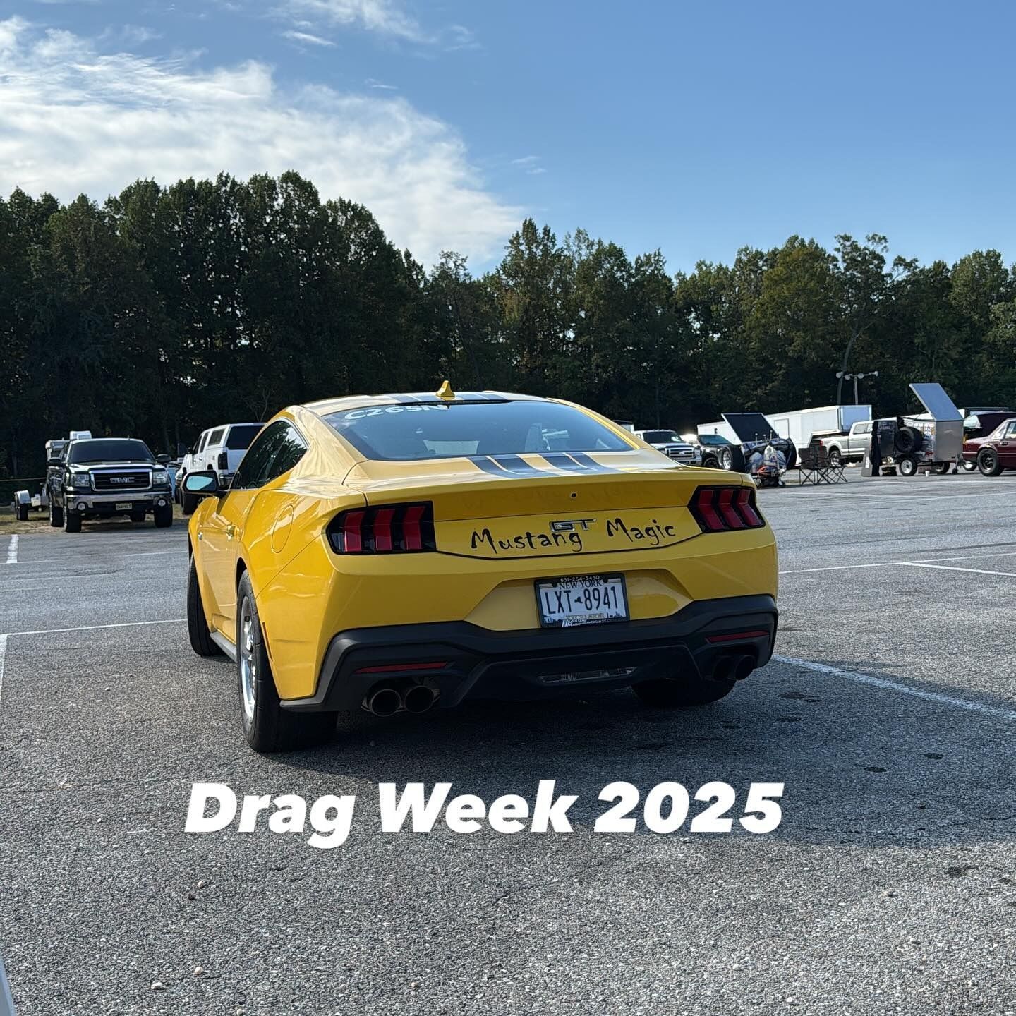Yellow Ford Mustang with racing stripes and 