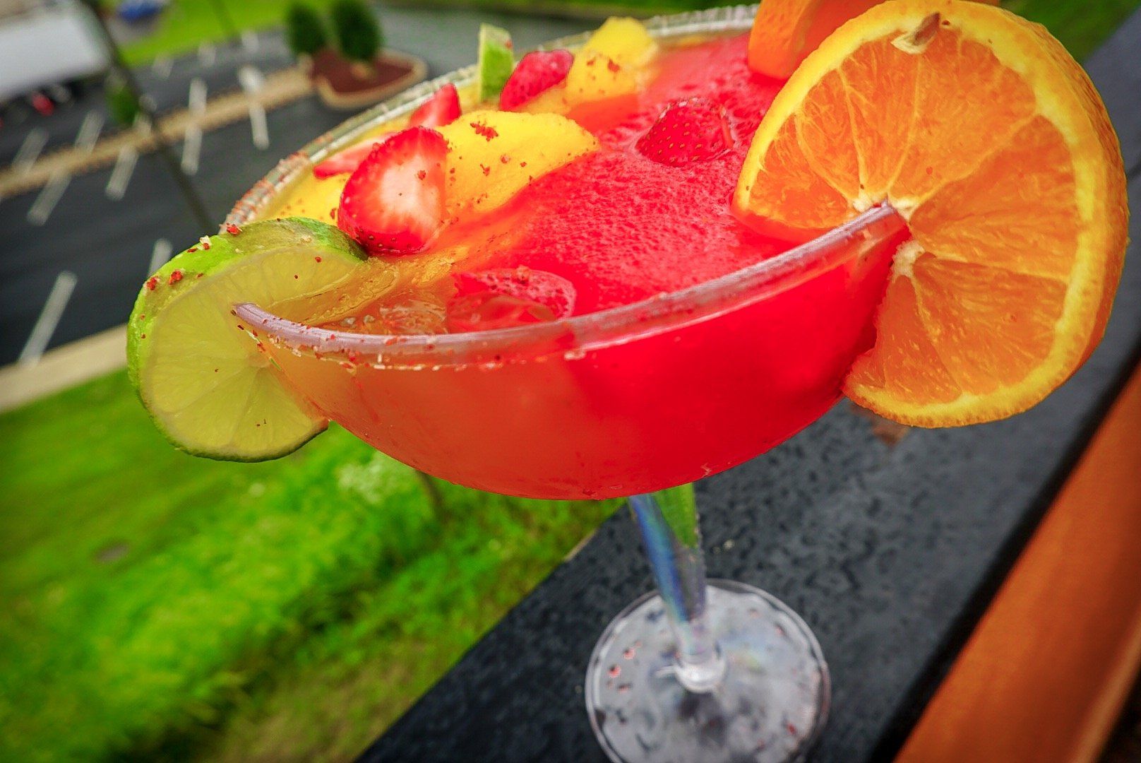 A close up of a martini with fruit in it on a table.