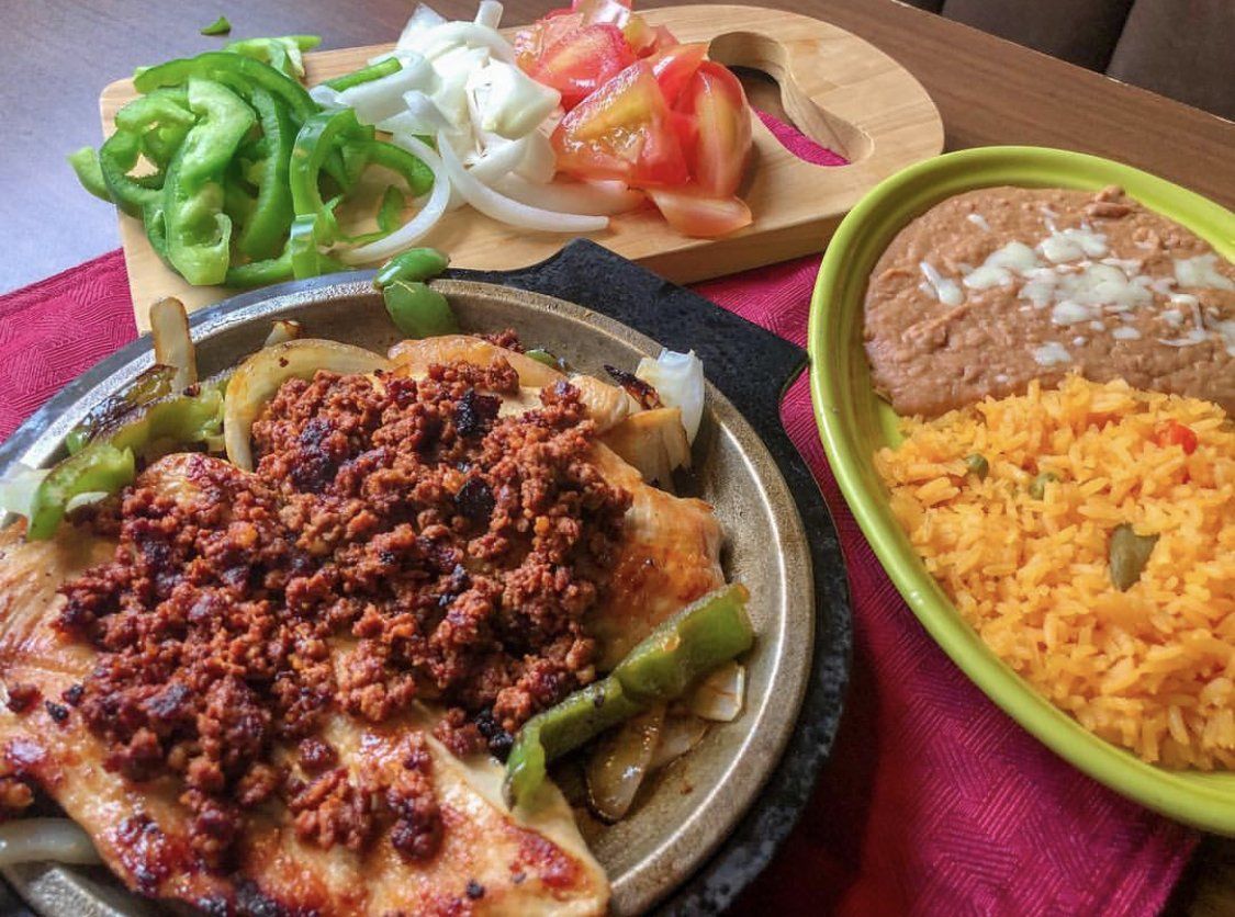 A plate of food with rice and beans on a table.