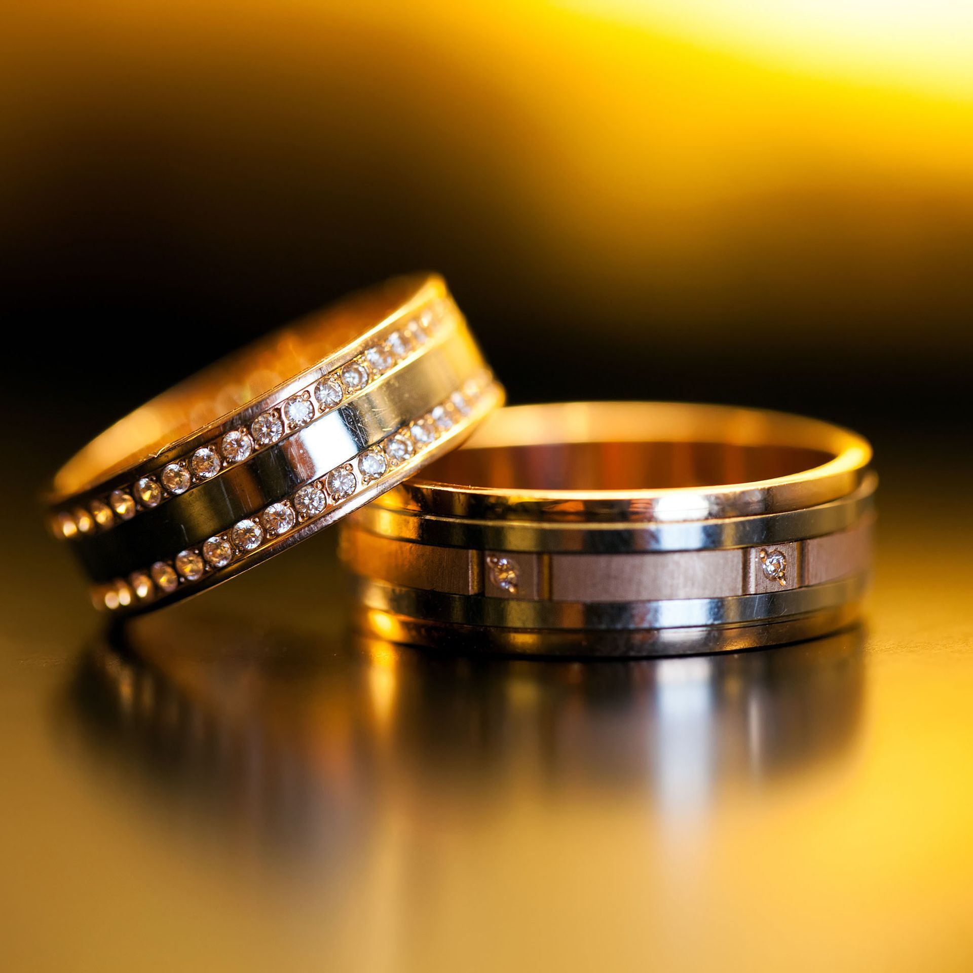 a close up of two wedding rings on a table