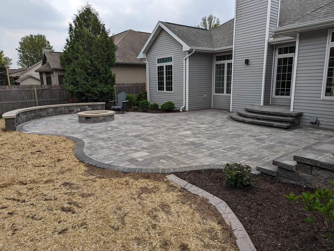 There is a fire pit in the backyard of a house.