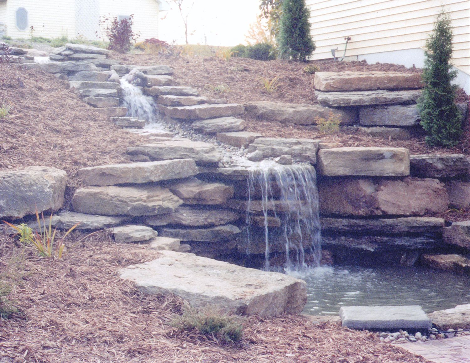 A patio with a table and chairs in front of a house