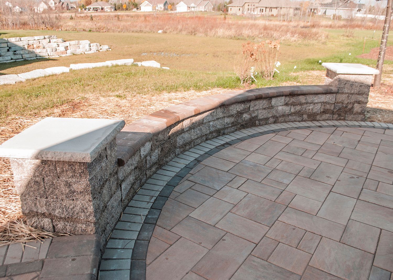A brick patio with a brick wall surrounding it