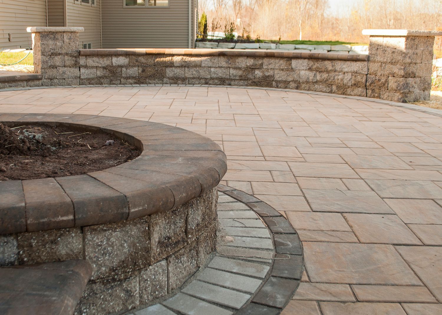 There is a fire pit in the middle of the patio.