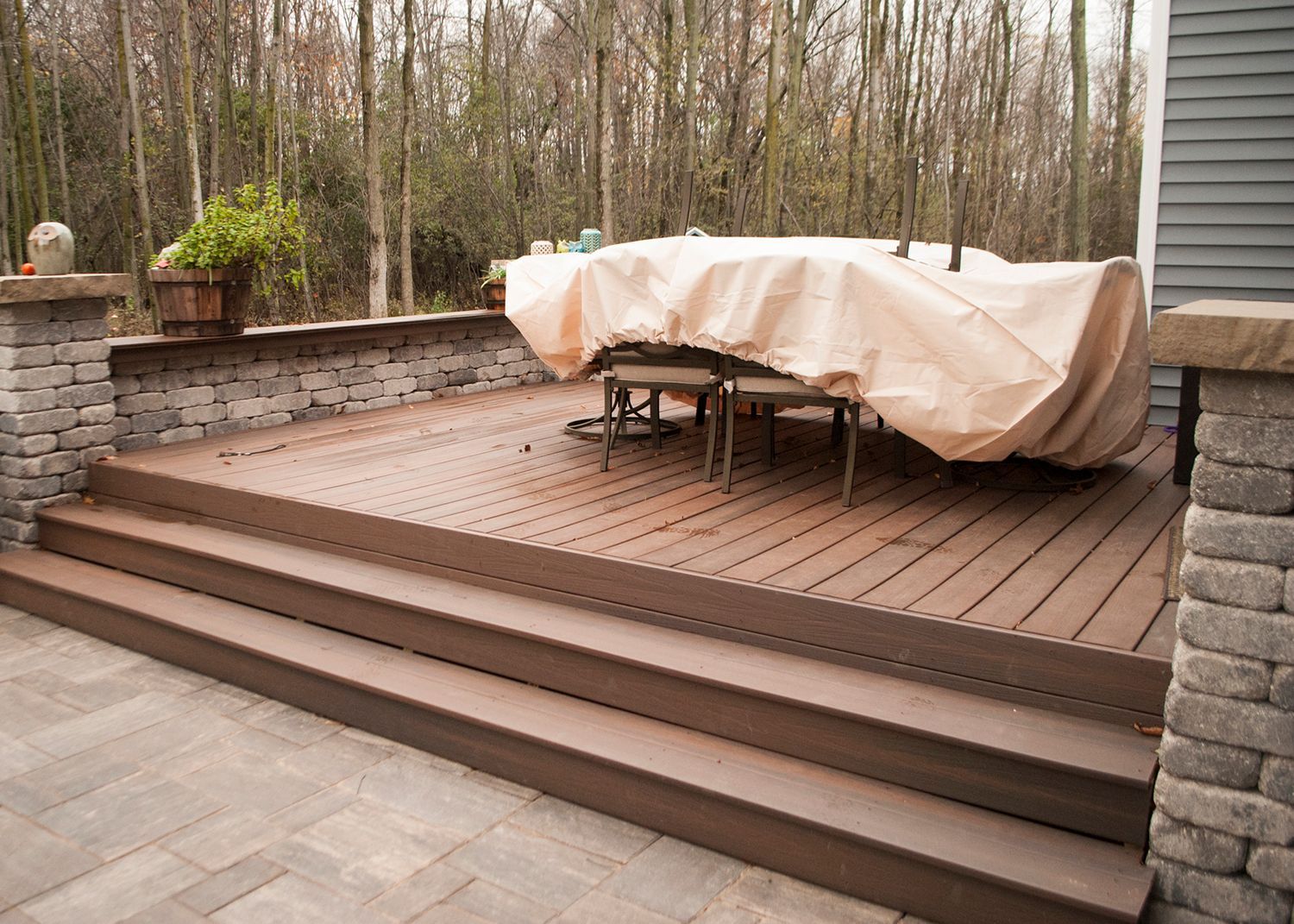 A wooden deck with a table and chairs on it.