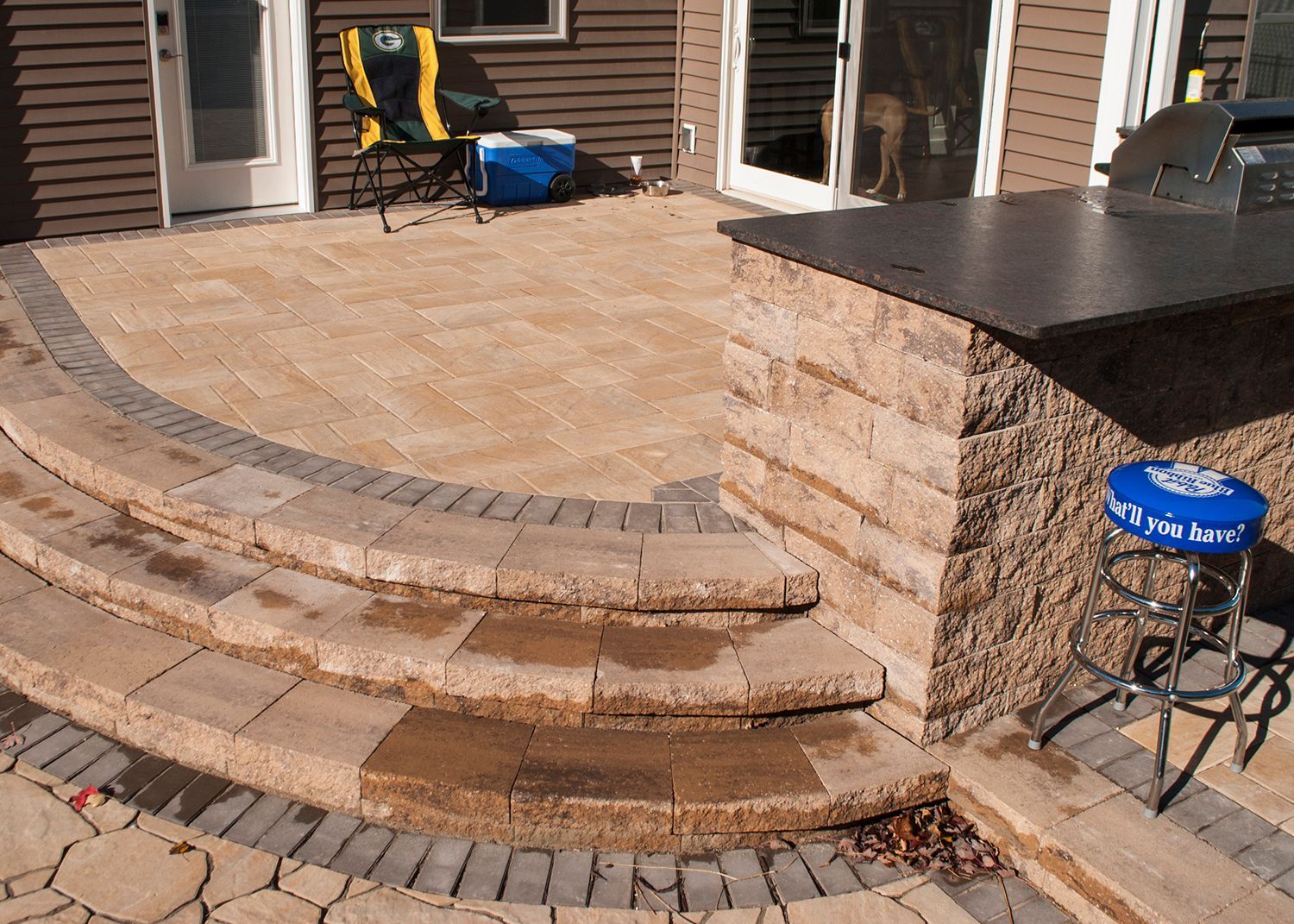 A patio with stairs and a bar that says bud light on it