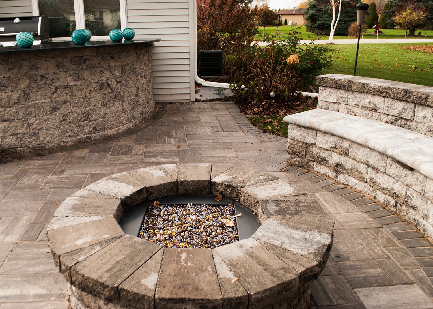 There is a fire pit in the middle of the patio.