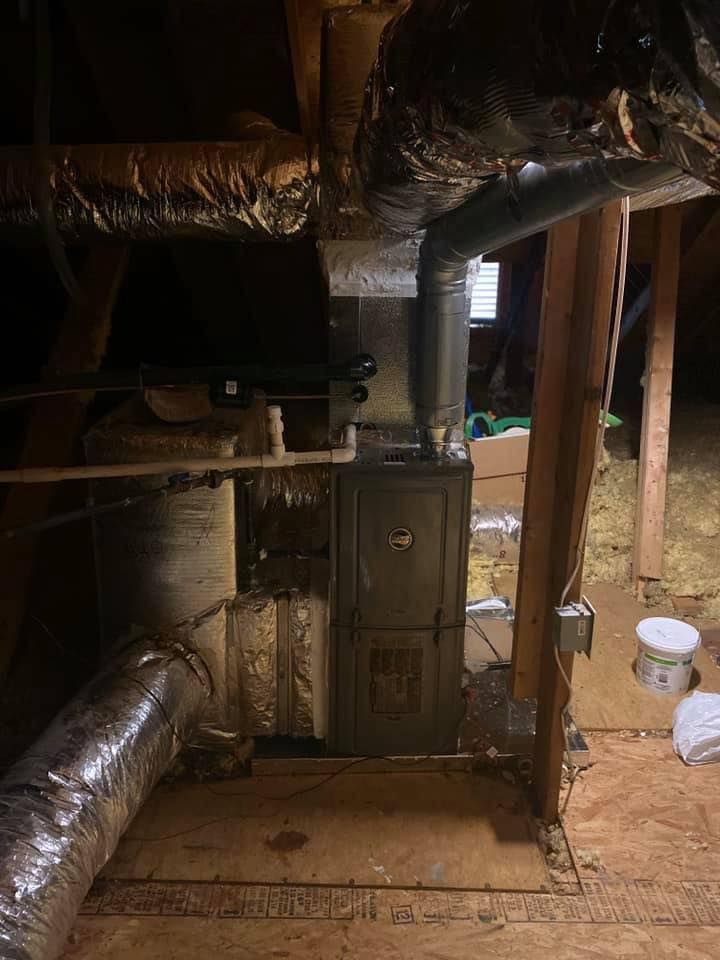 There is a furnace in the attic of a house.