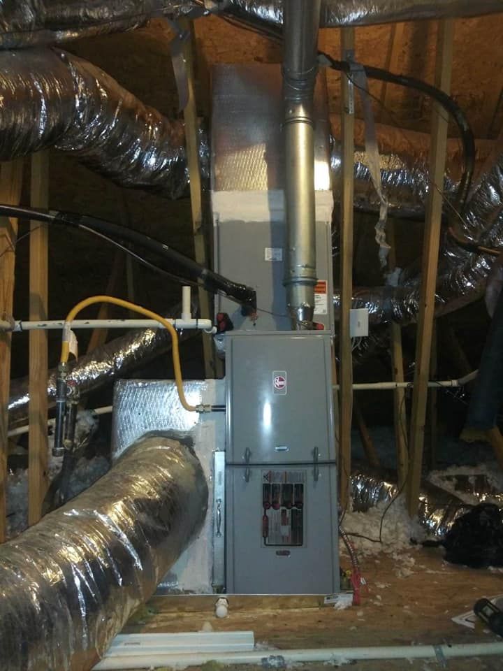 An air conditioner is installed in the attic of a house