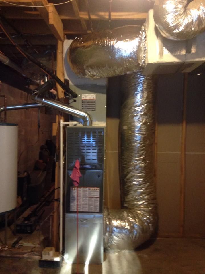 A picture of an air conditioner in a basement.