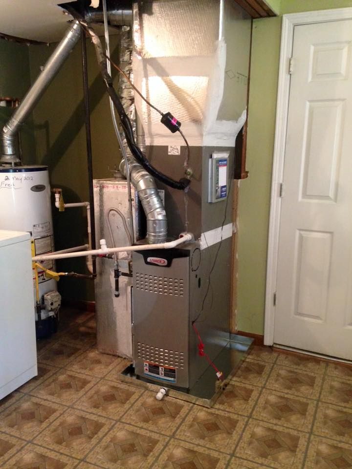 A room with a heater and a water heater in it.