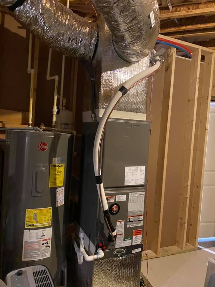 There is a water heater and an air conditioner in the basement.