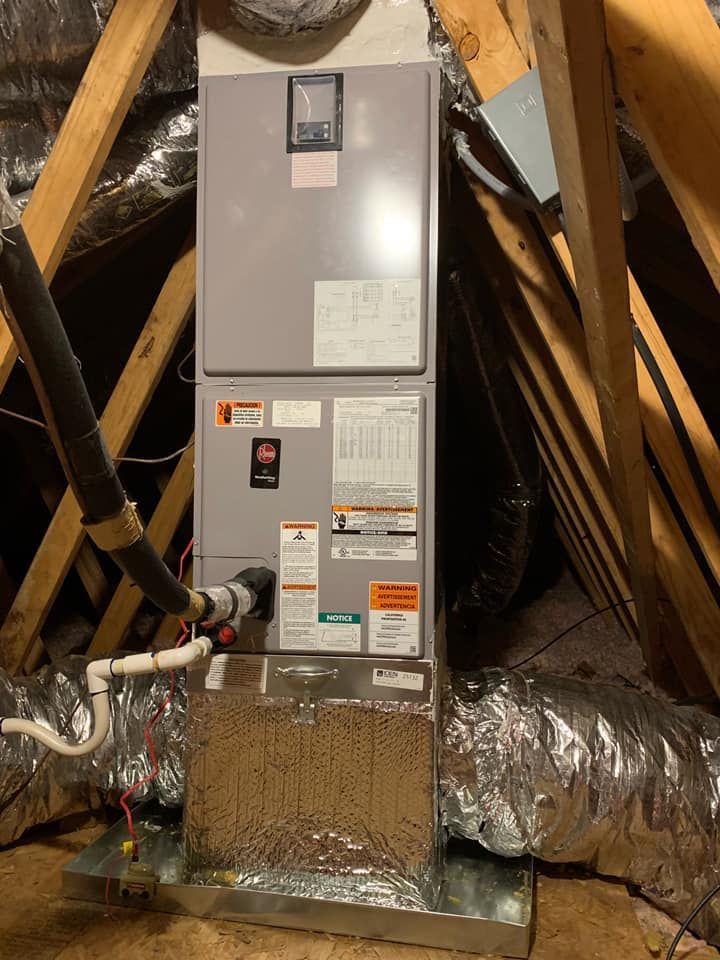 An air conditioner is sitting in the attic of a house.
