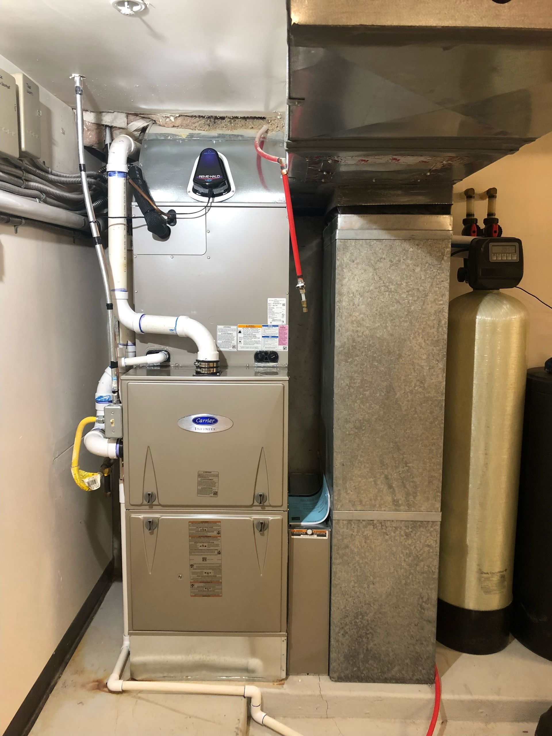 A basement with a heating and cooling system and a water filter.