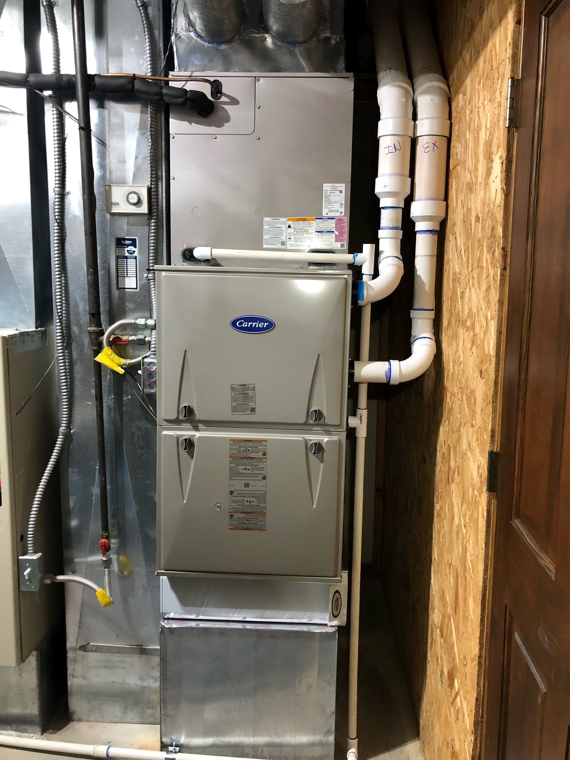 A stainless steel air conditioner is installed in the basement.