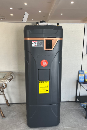 Tall black kiosk-style machine with orange accents in a showroom or lobby area