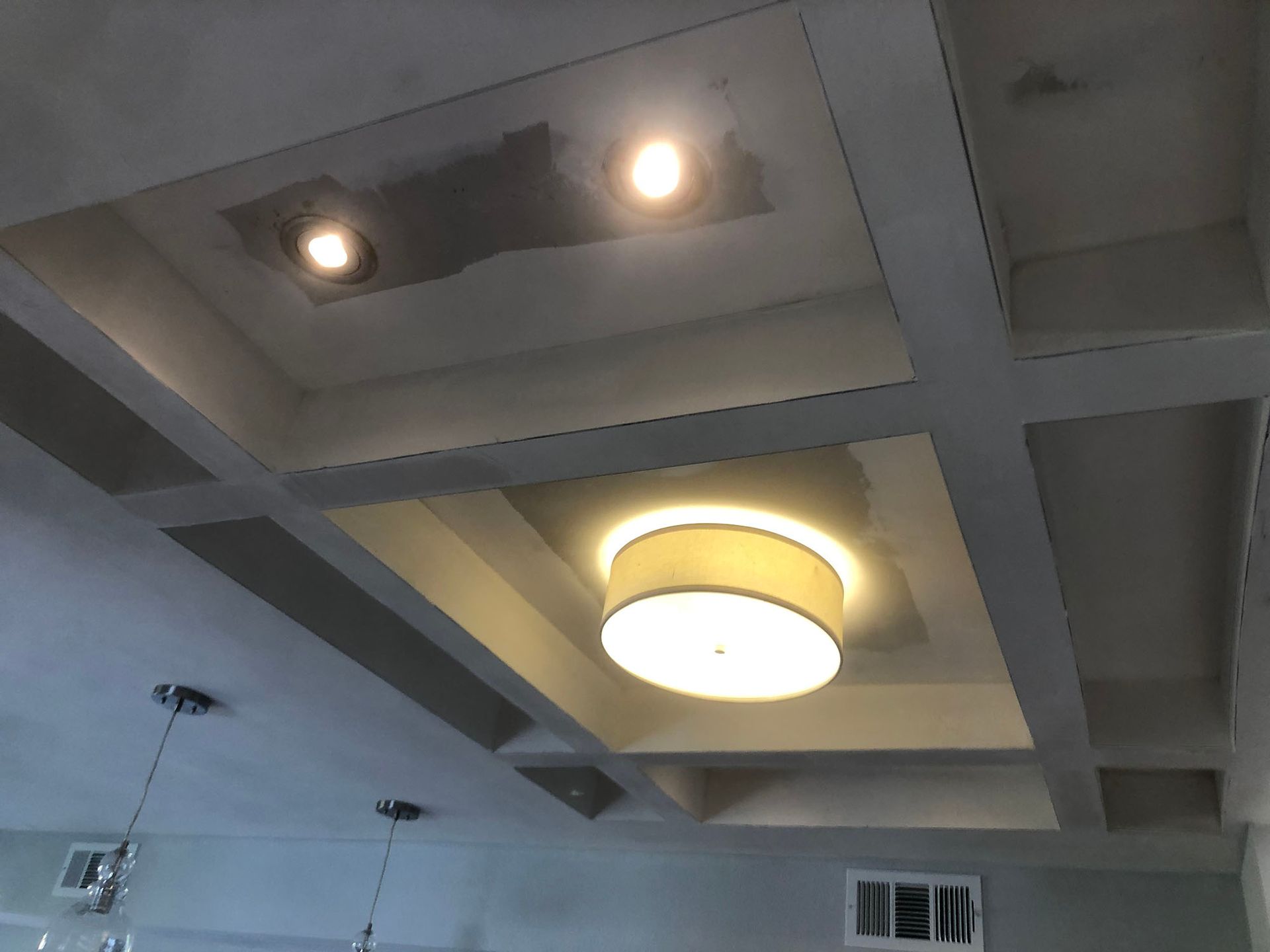 A ceiling with a light hanging from it