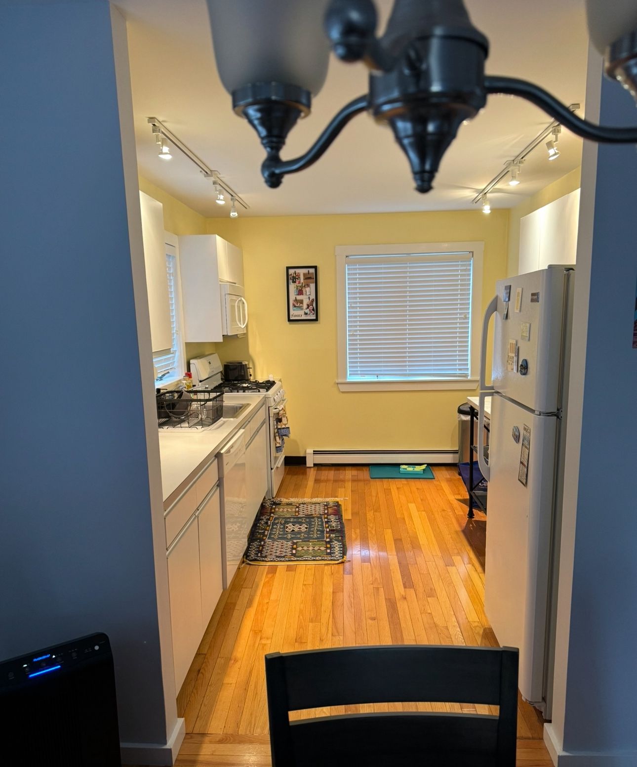 A bathroom with two sinks, a toilet, and a window.