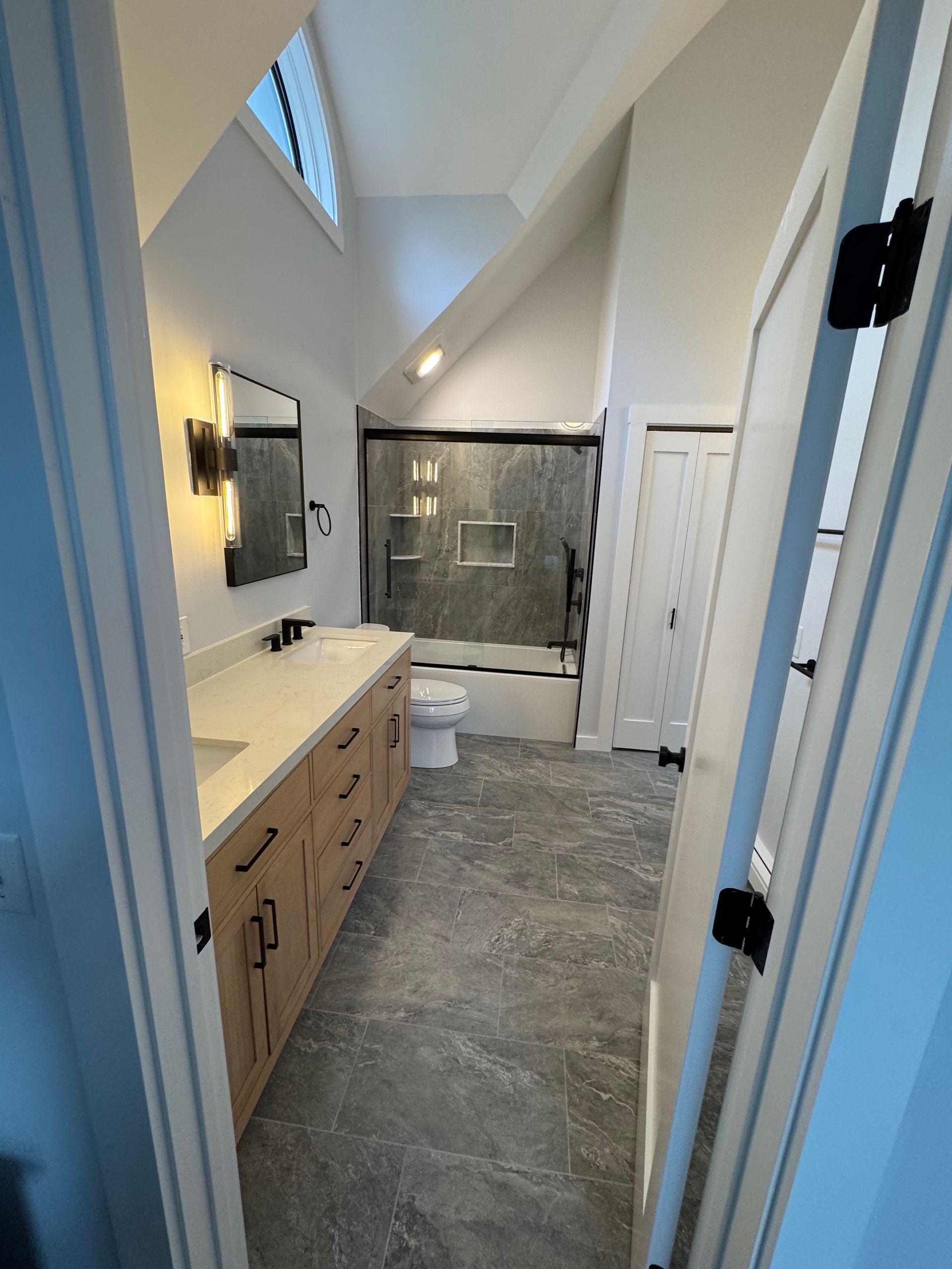 A bathroom with a sink, toilet, and shower.