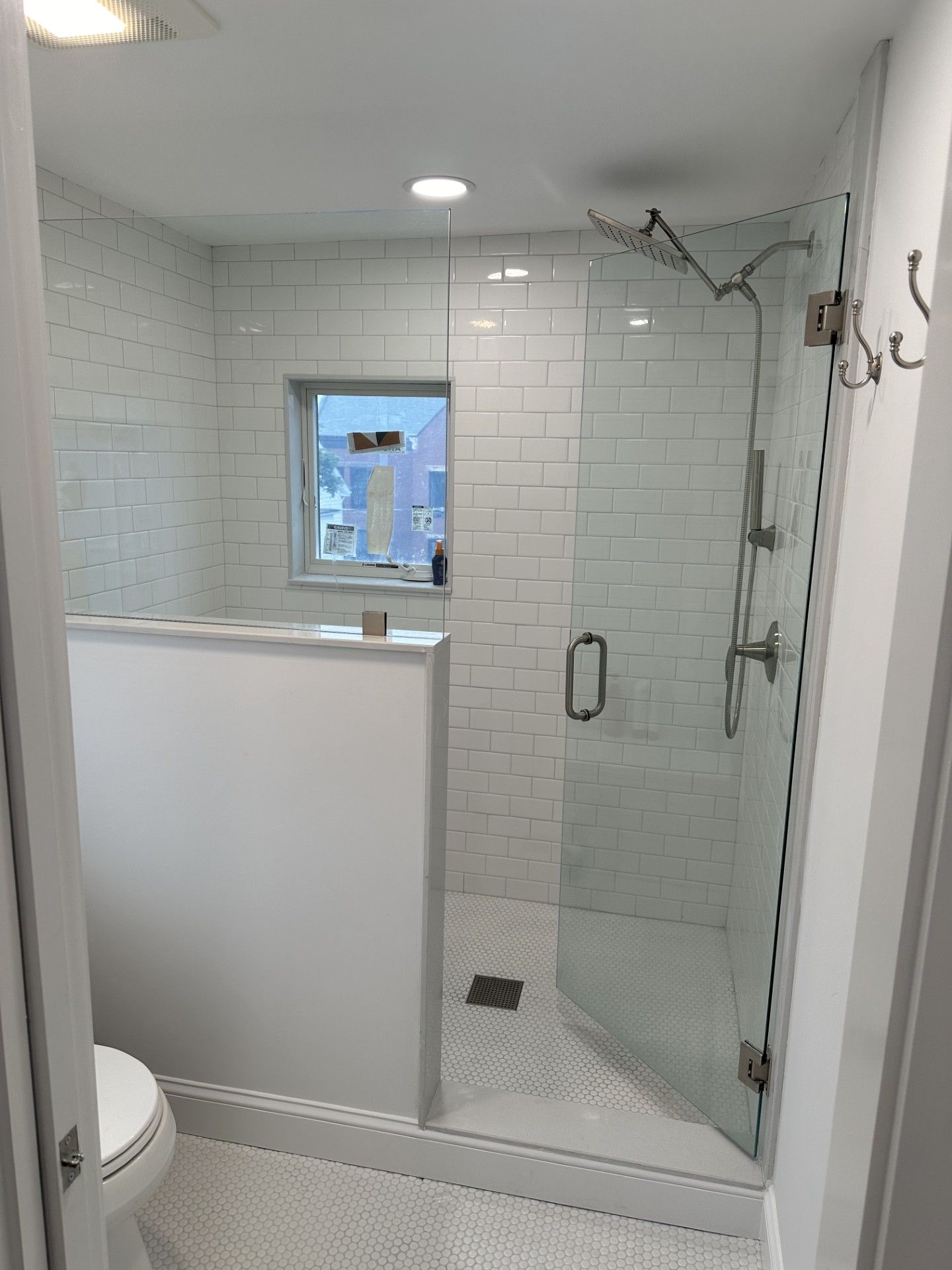 A clean bathroom with a walk-in shower and a toilet