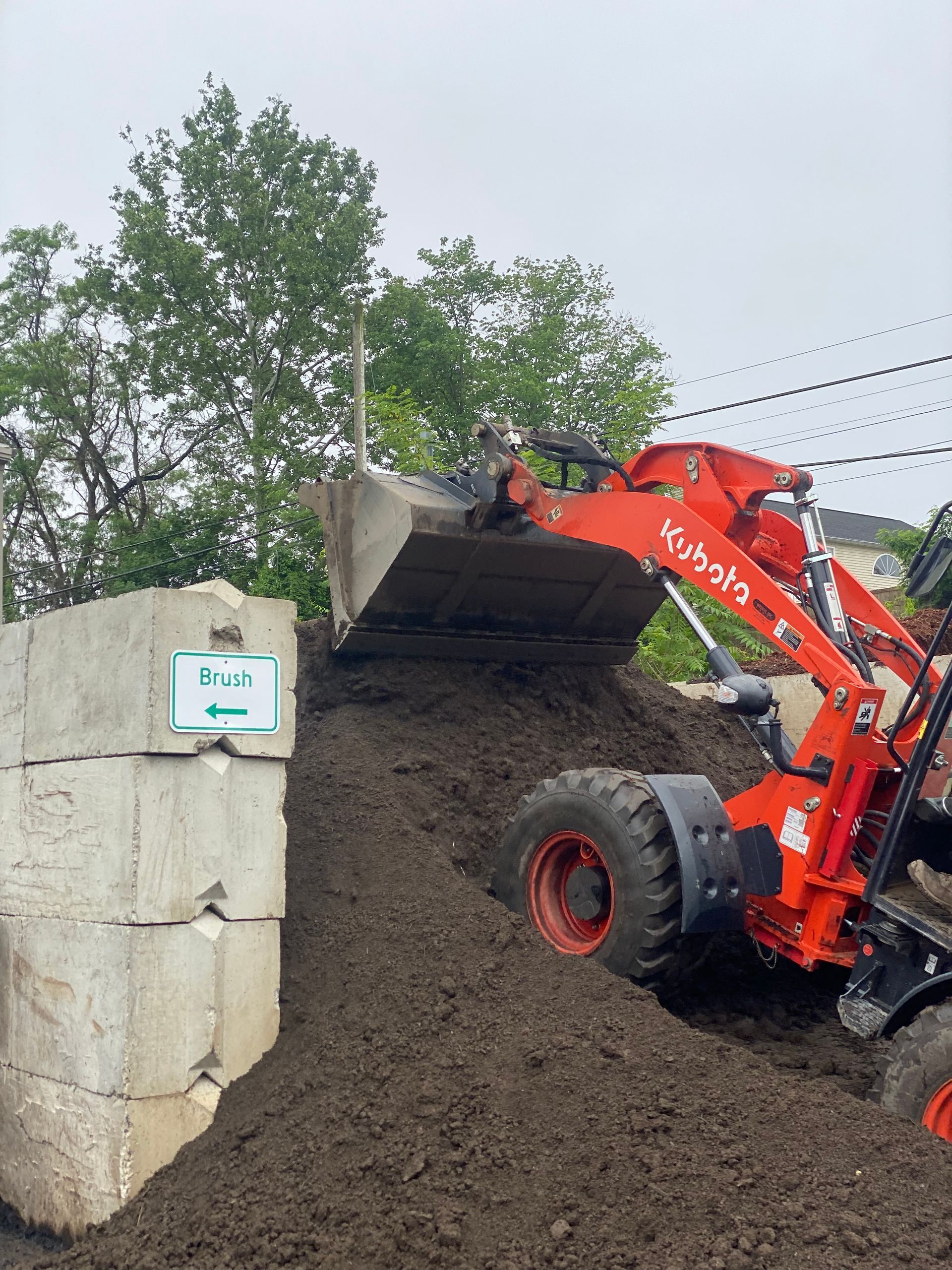 A bulldozer is loading dirt into a concrete block.