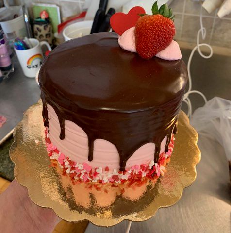 strawberry cake with chocolate ganache on top