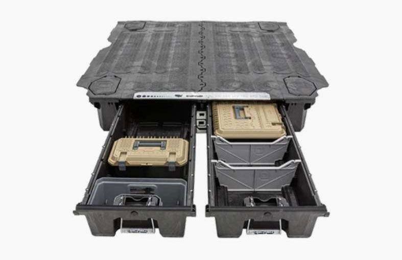 A black, two-drawer vehicle cargo storage system with open drawers containing organized tan cases and dividers.