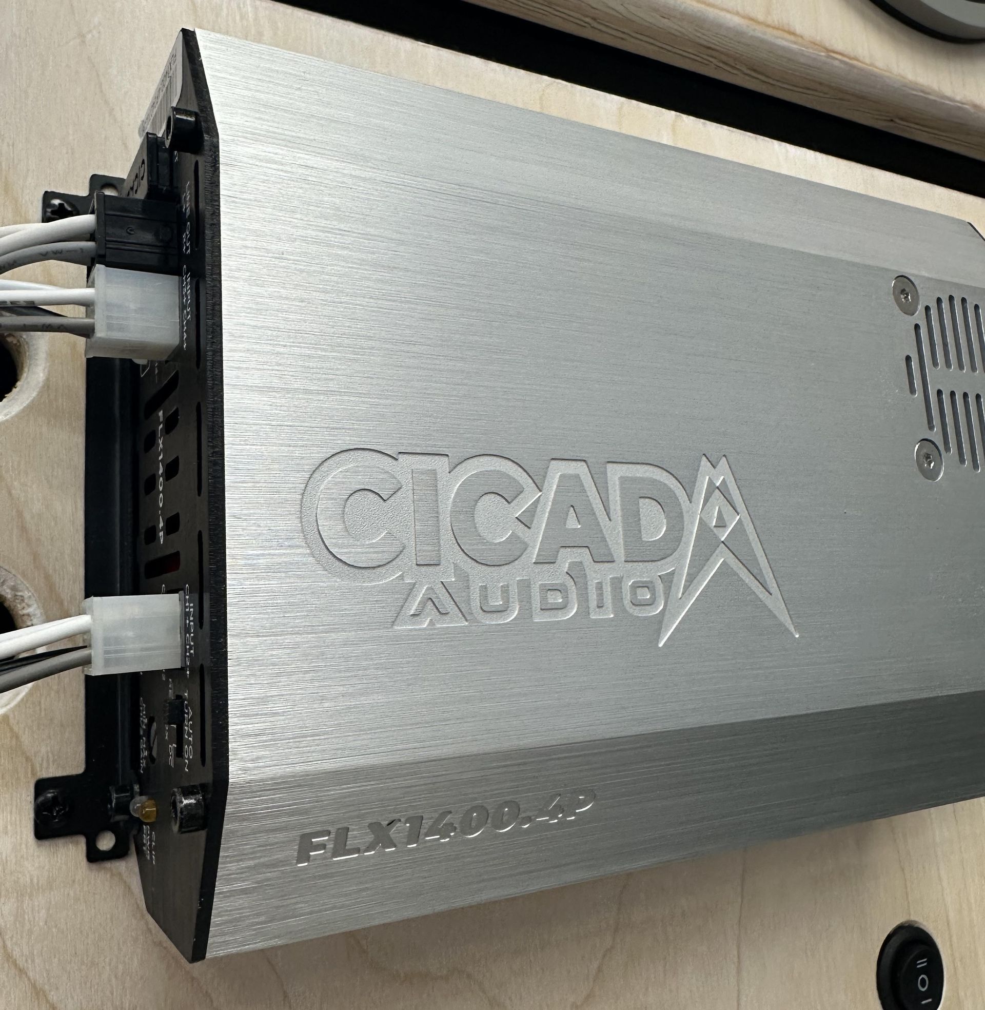 A cicada audio amplifier is sitting on a wooden table