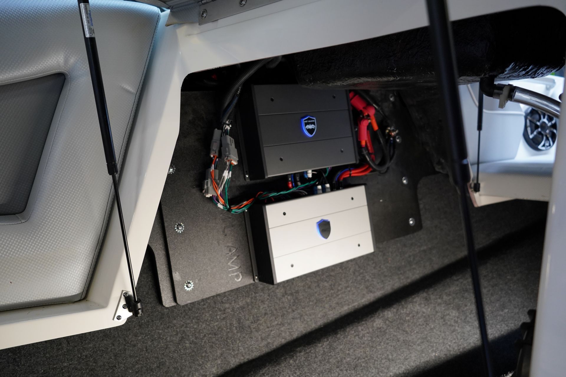 A subwoofer is sitting in the back of a boat