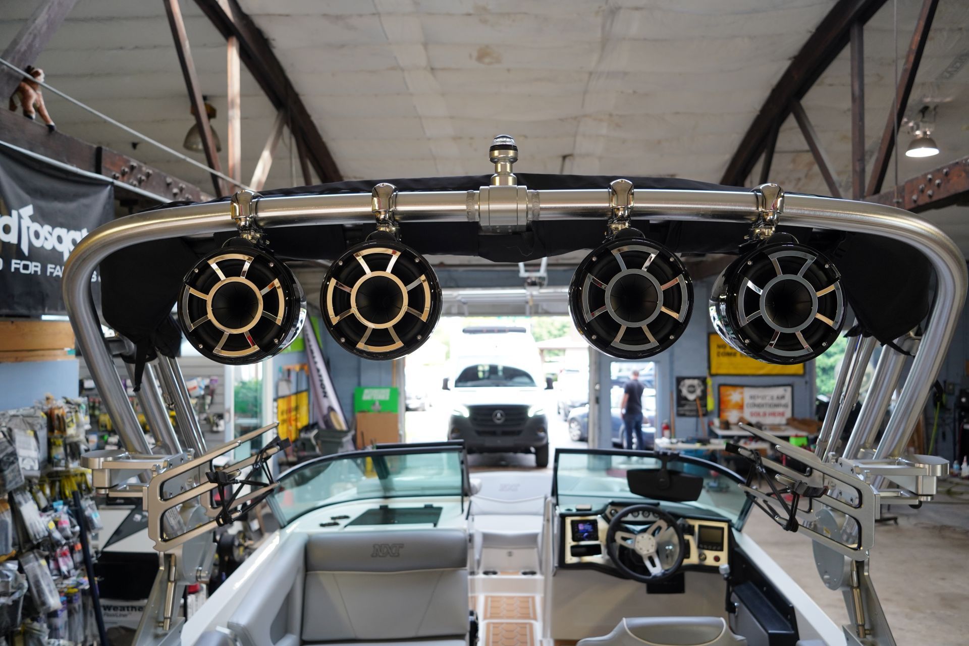 A boat with speakers on top of it in a garage