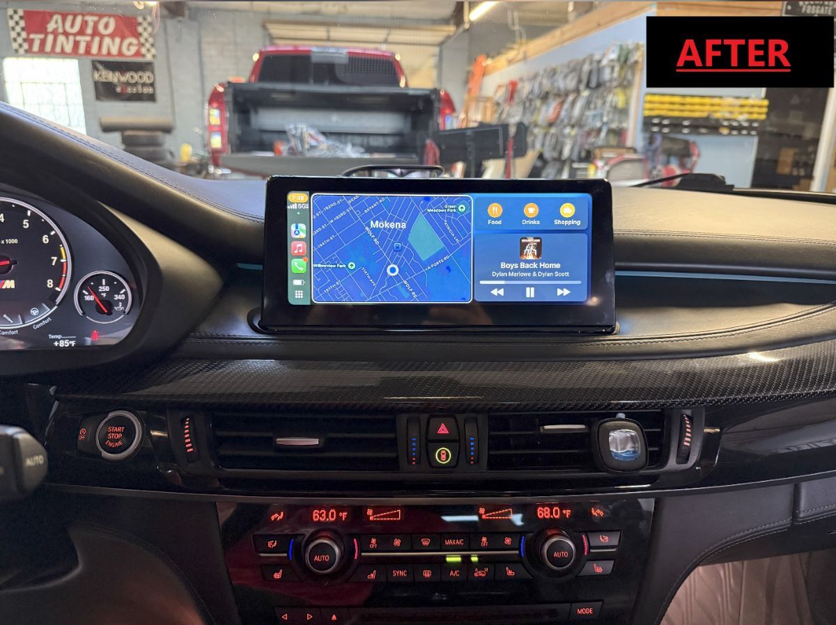 A picture of a car dashboard with a phone on it.