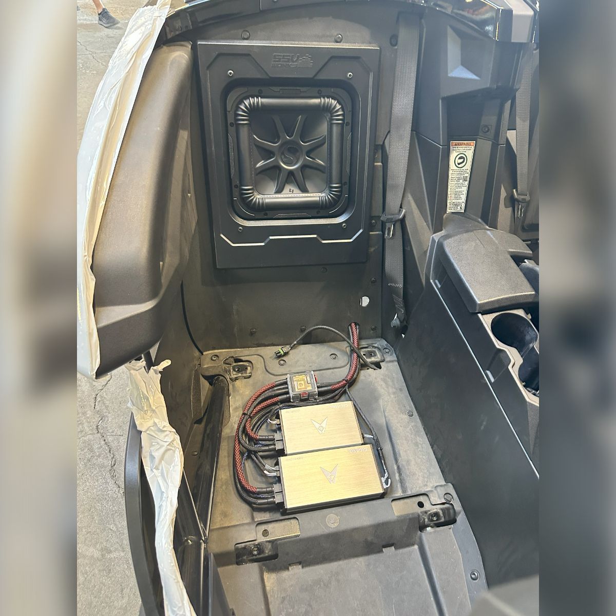 A picture of the inside of a car with a speaker in the back.
