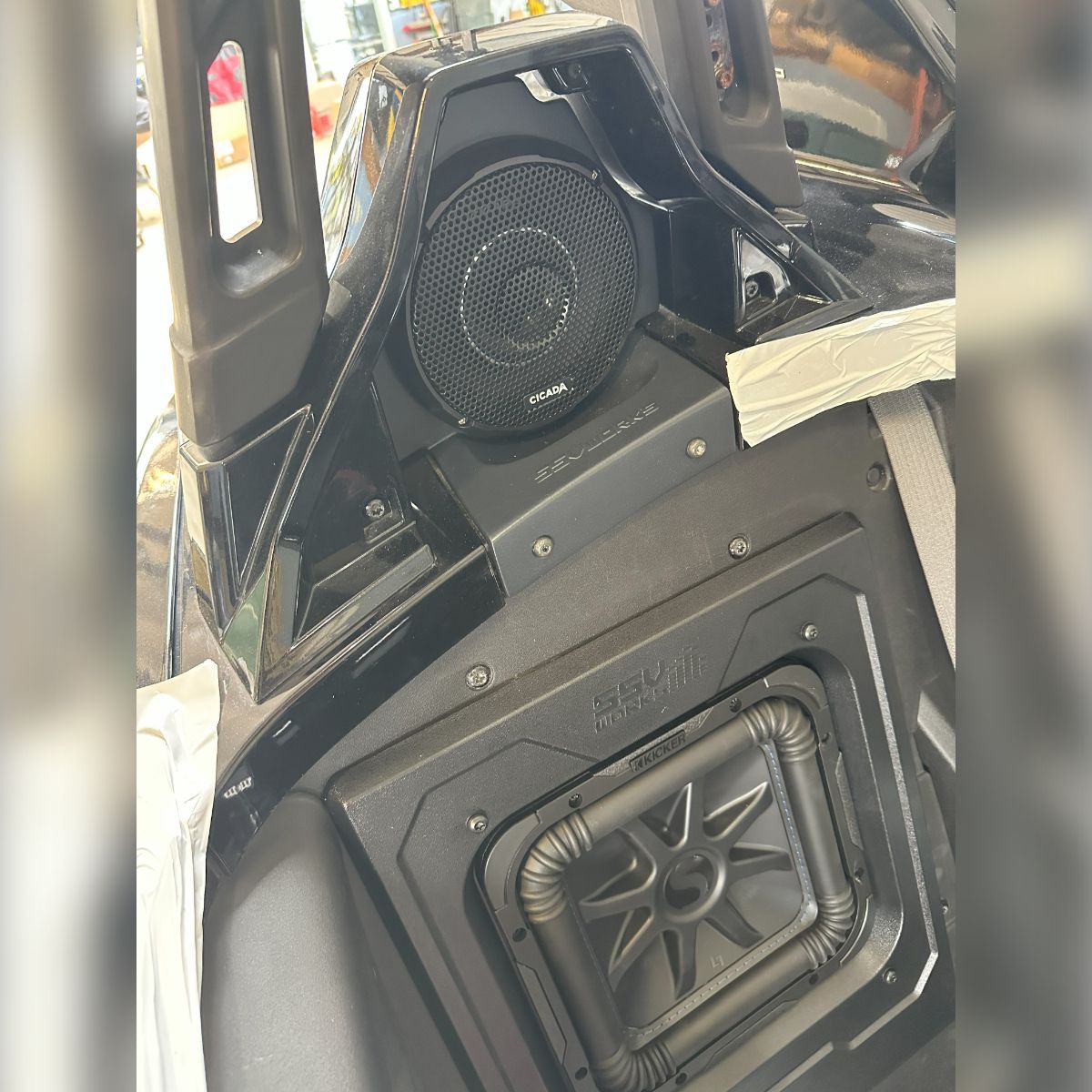 A speaker is mounted to the side of a vehicle.