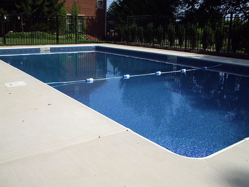 A large swimming pool with a fence around it