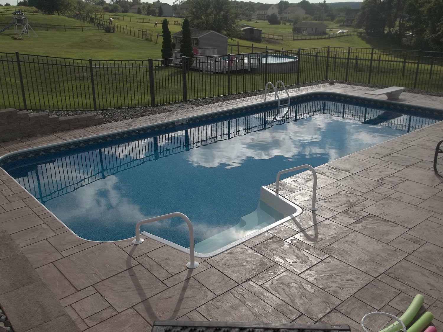 A large swimming pool with a fence around it