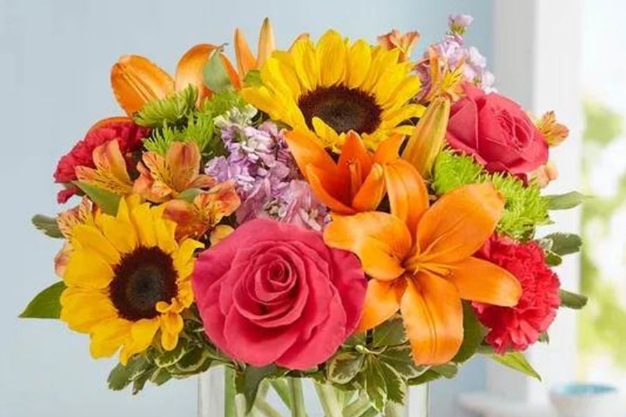 A large bouquet of vibrant red roses with green stems and leaves.