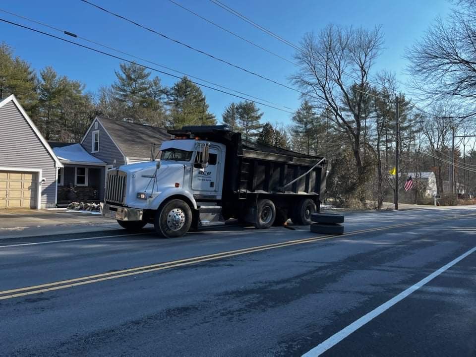 A dump truck is parked on the side of the road